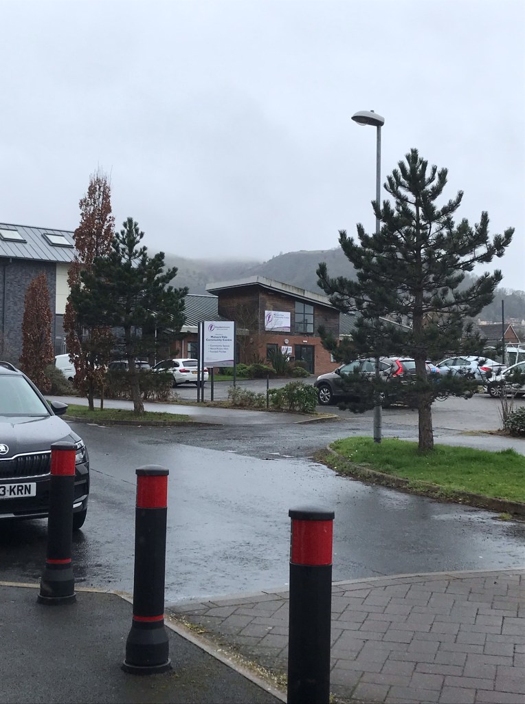 A view from Malvern Vale up to a cloudy End Hill.